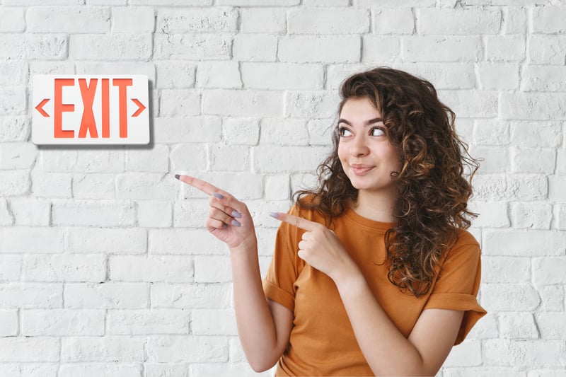 Woman pointing at Exit sign Woman pointing at Exit sign